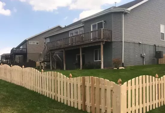 Wooden fence around houses and yard.